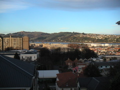 The view out my window - hehe, I wish.  Close though; I took it from just up the street.  You can see across the bay to Otago Peninsula.  The closer tall building is part of the Uni (as they call it here).